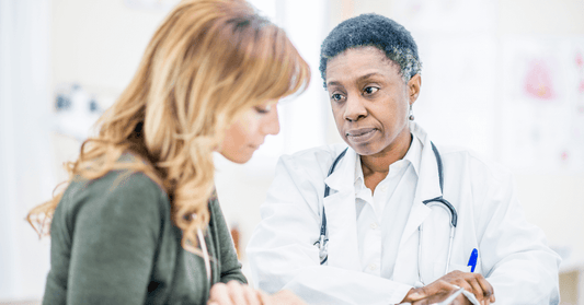 Doctor explaining sciatica diagnosis to patient.